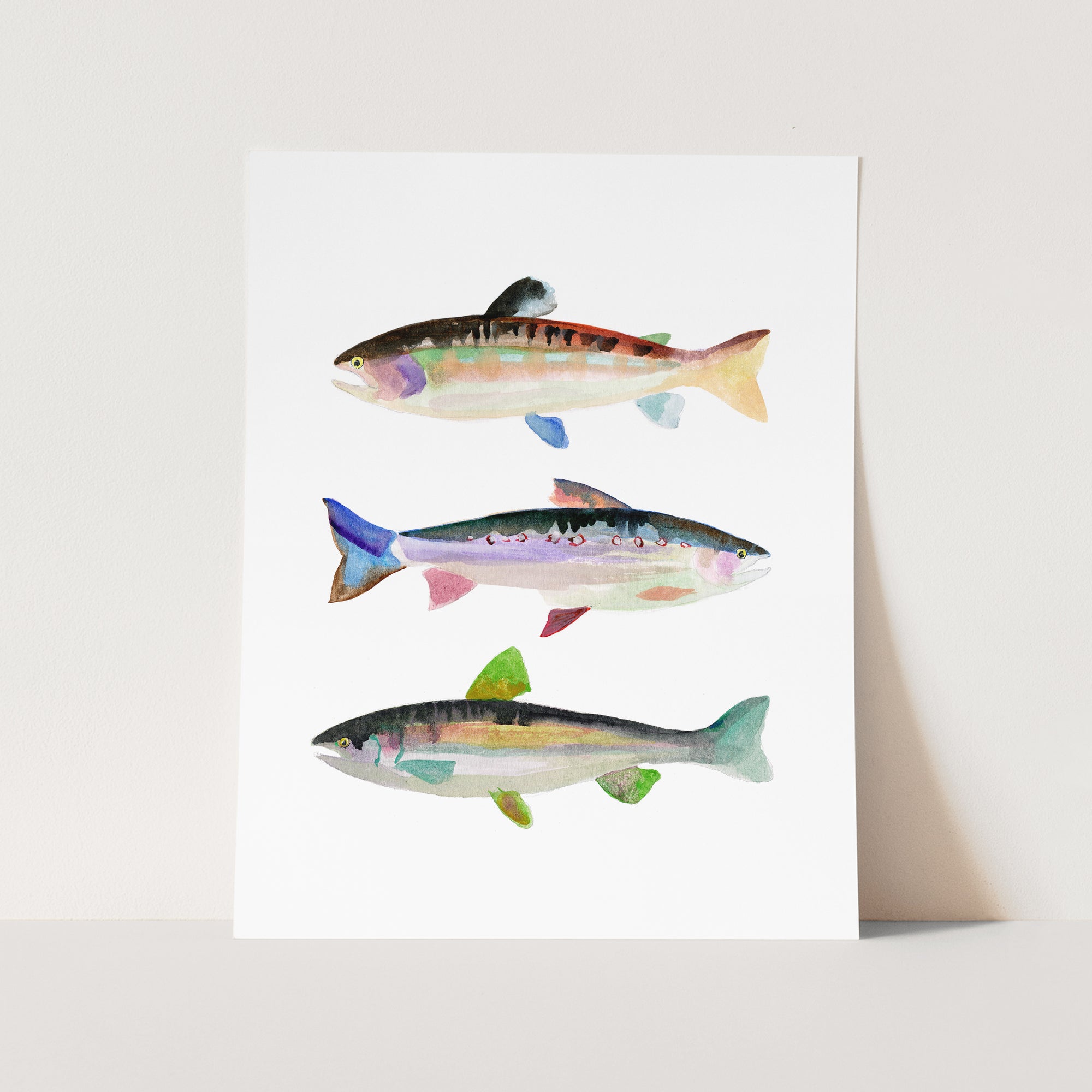 a card with three fish painted on it