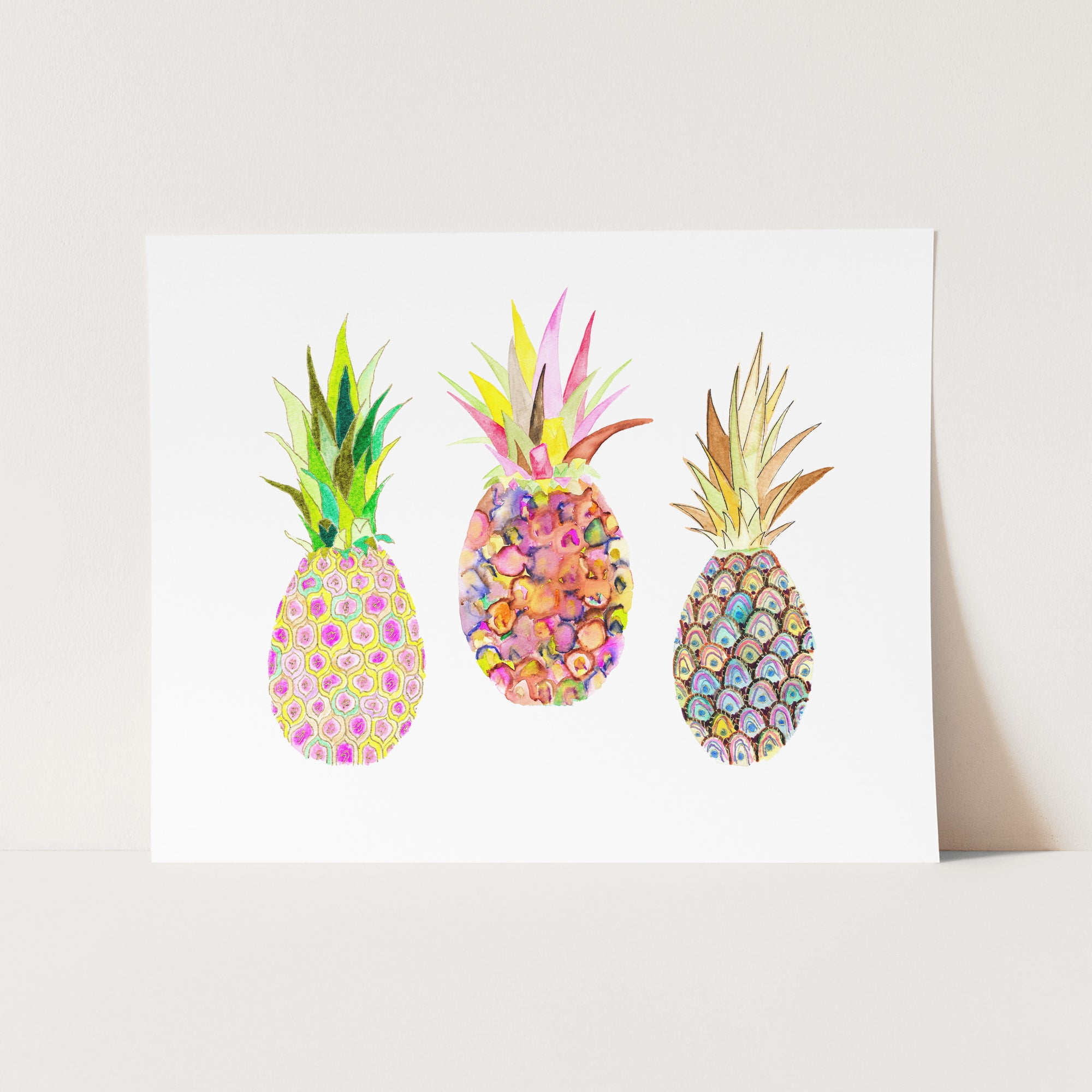 three pineapples are painted on a white card