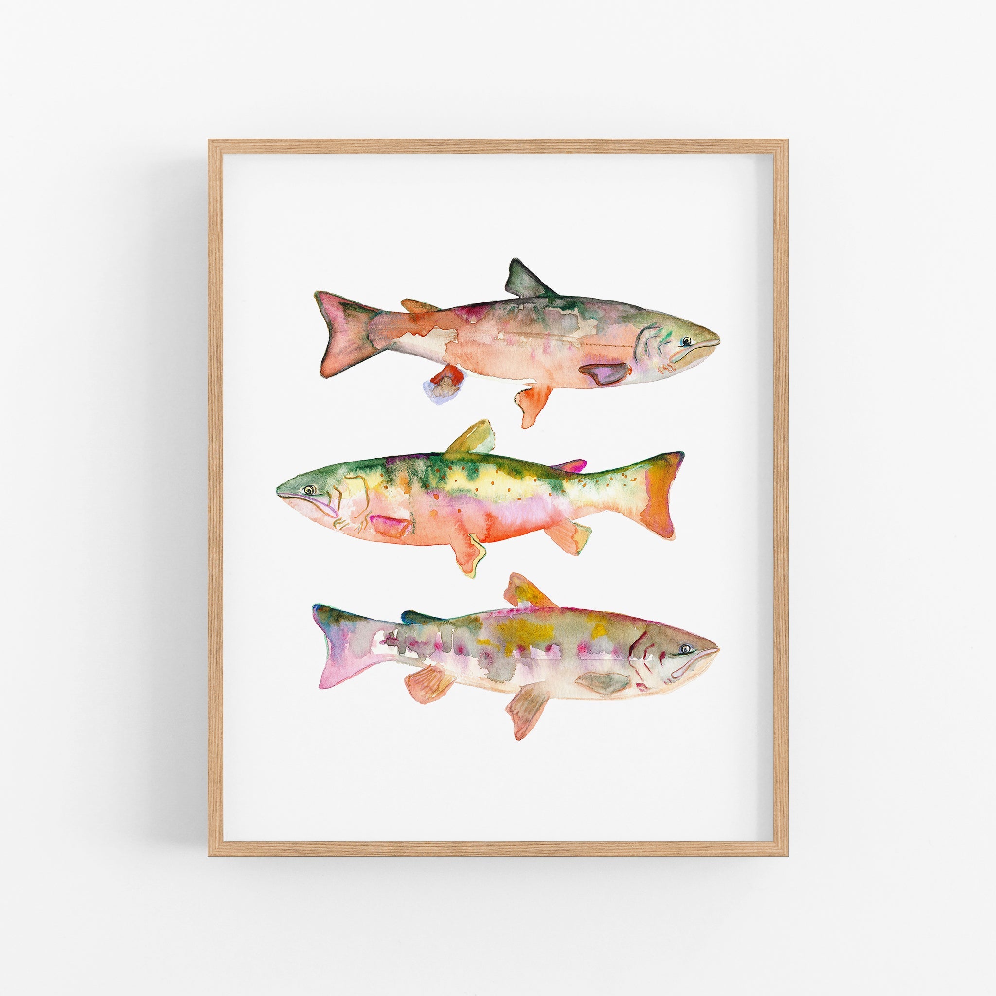 a painting of three fish on a white wall