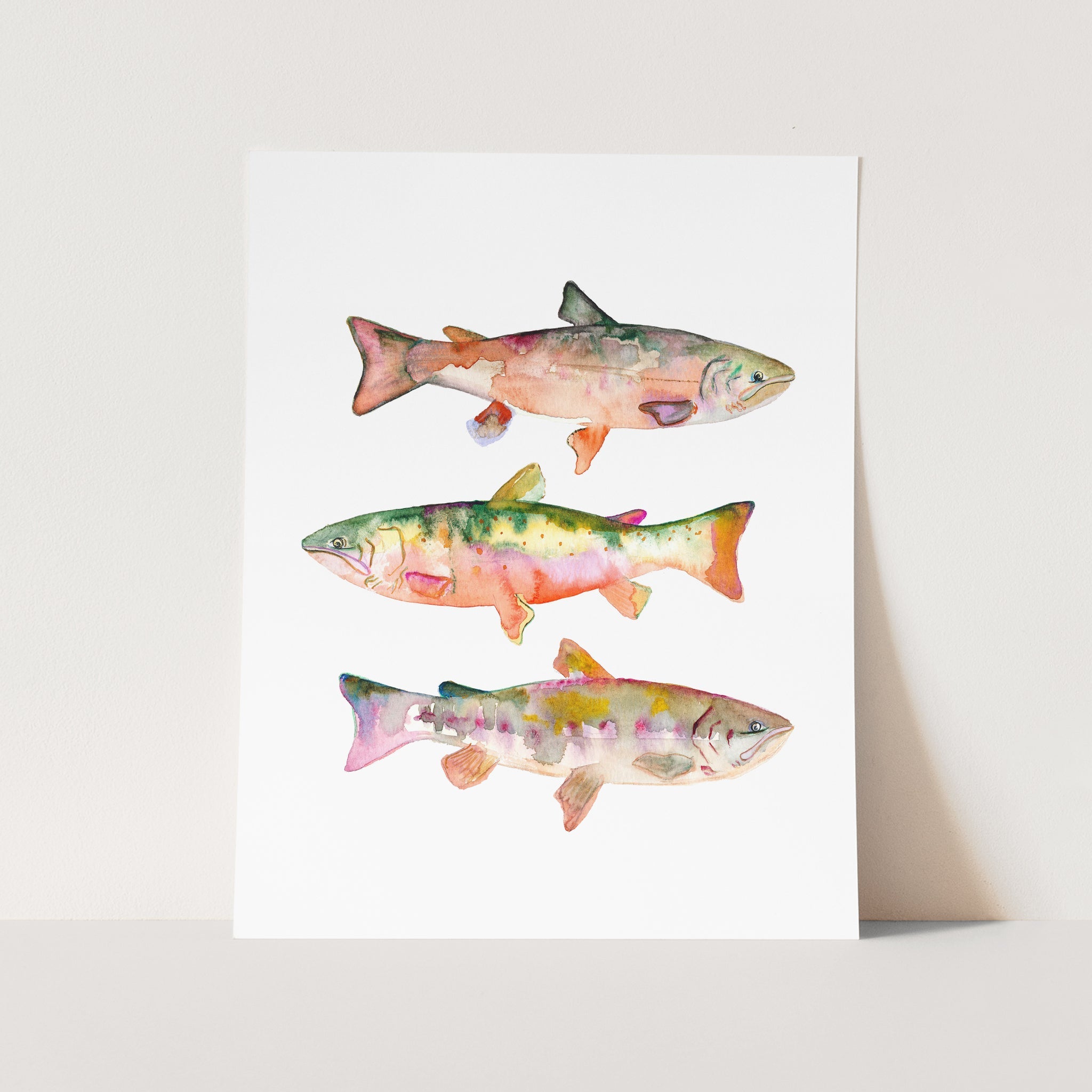 a card with three fish painted on it