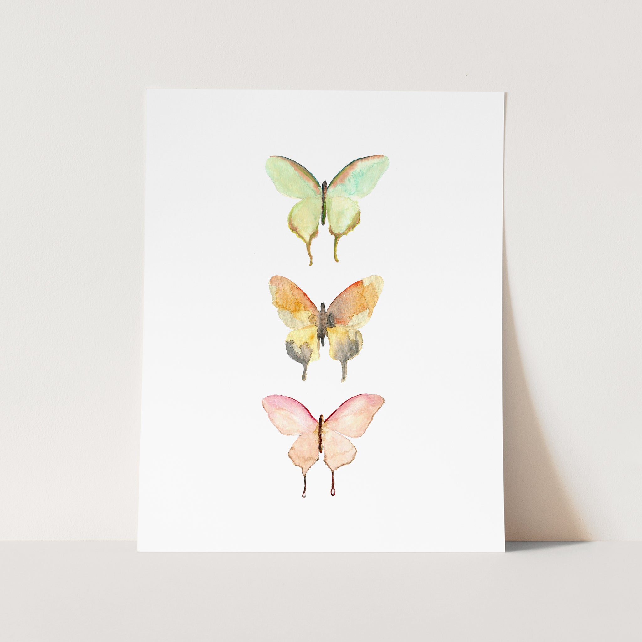 a card with three butterflies painted on it