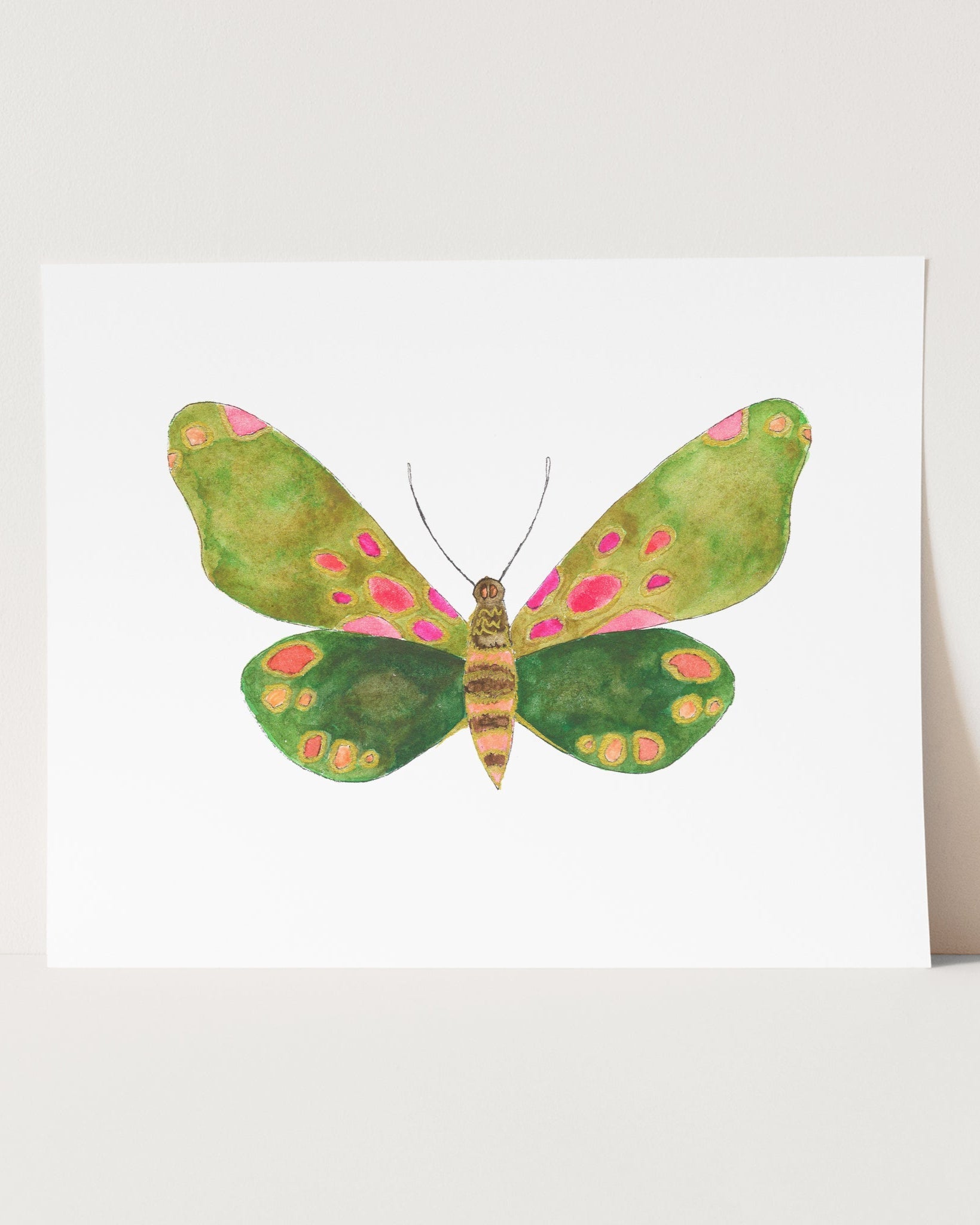 a card with a green and pink butterfly on it