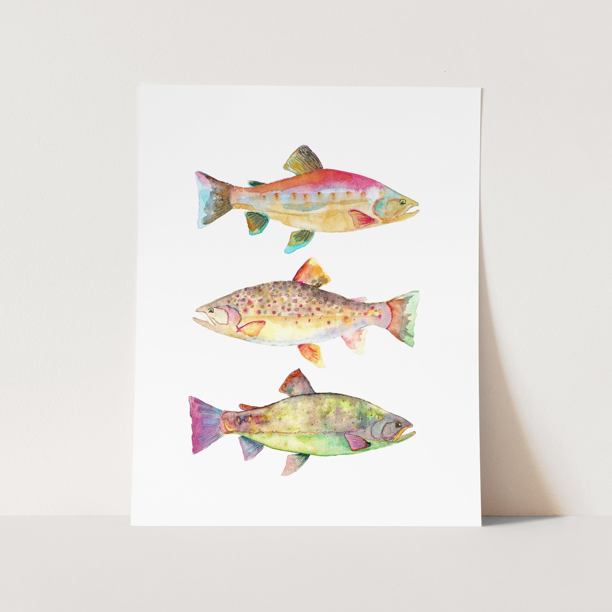 a card with three fish painted on it