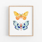 a painting of two butterflies on a white wall