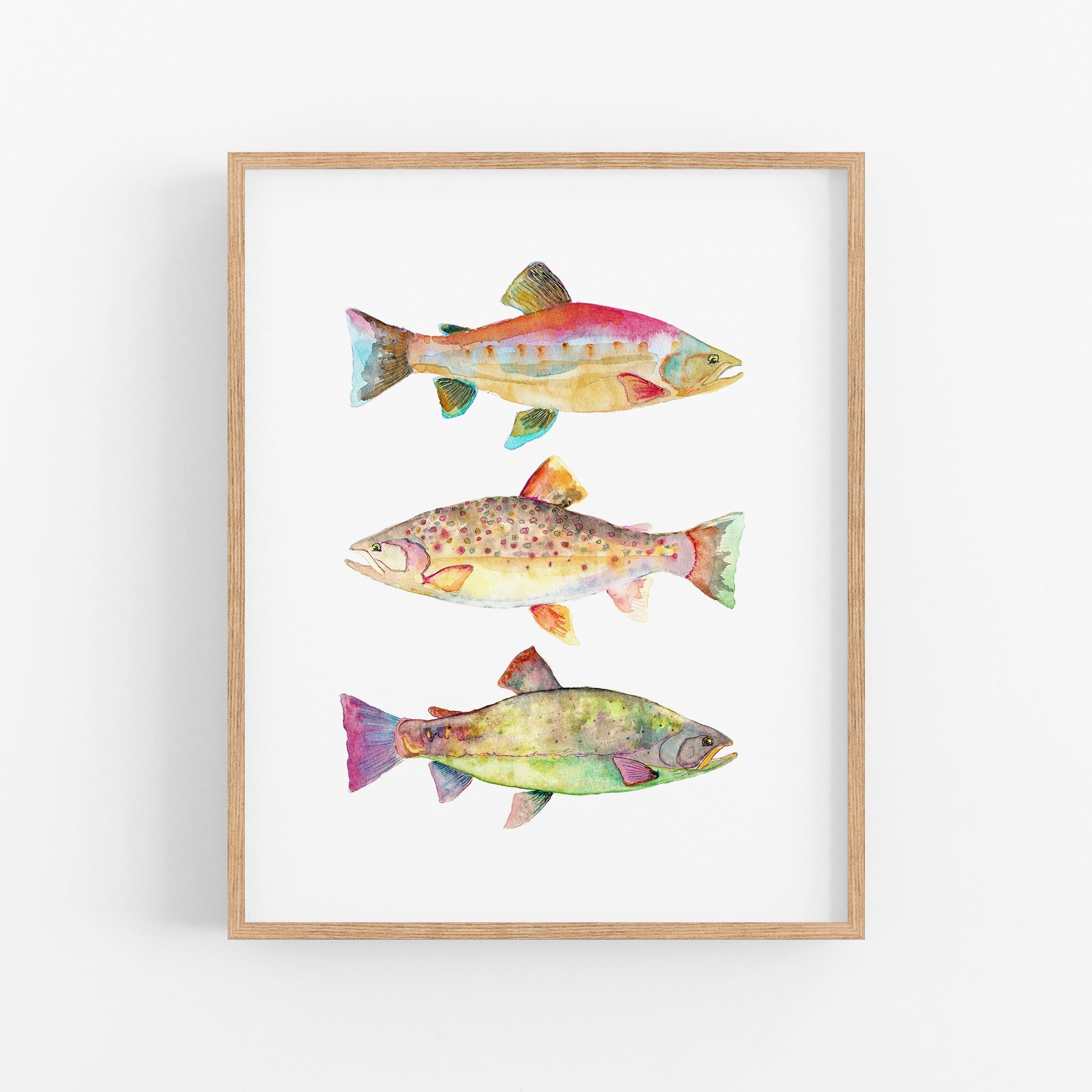 a painting of three fish on a white wall