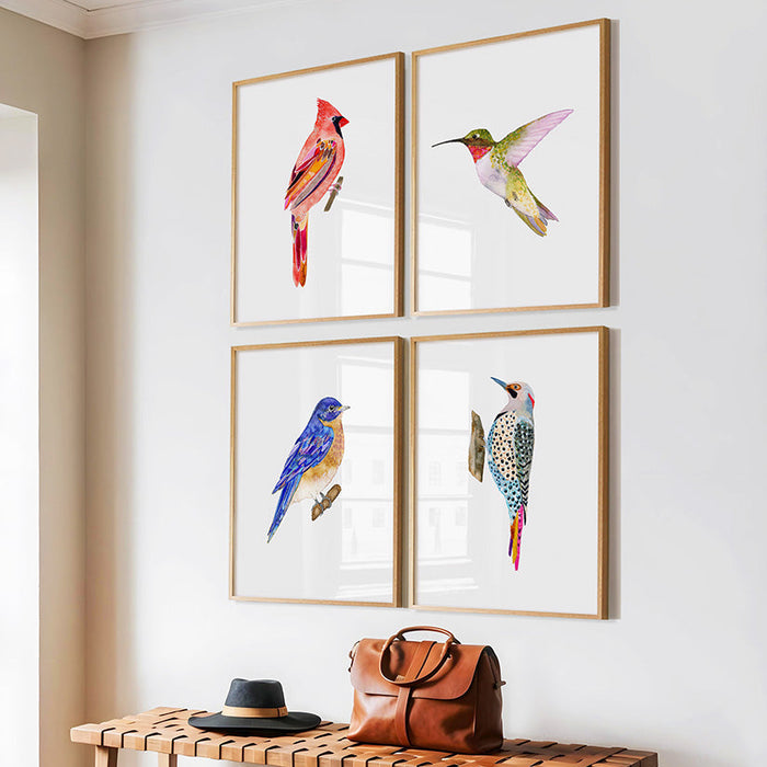 Wooden bench with a brown leather bag and black shoes against a wall with framed bird art.