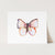 a watercolor painting of a butterfly on a card