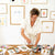 a woman in a white shirt is painting on a table