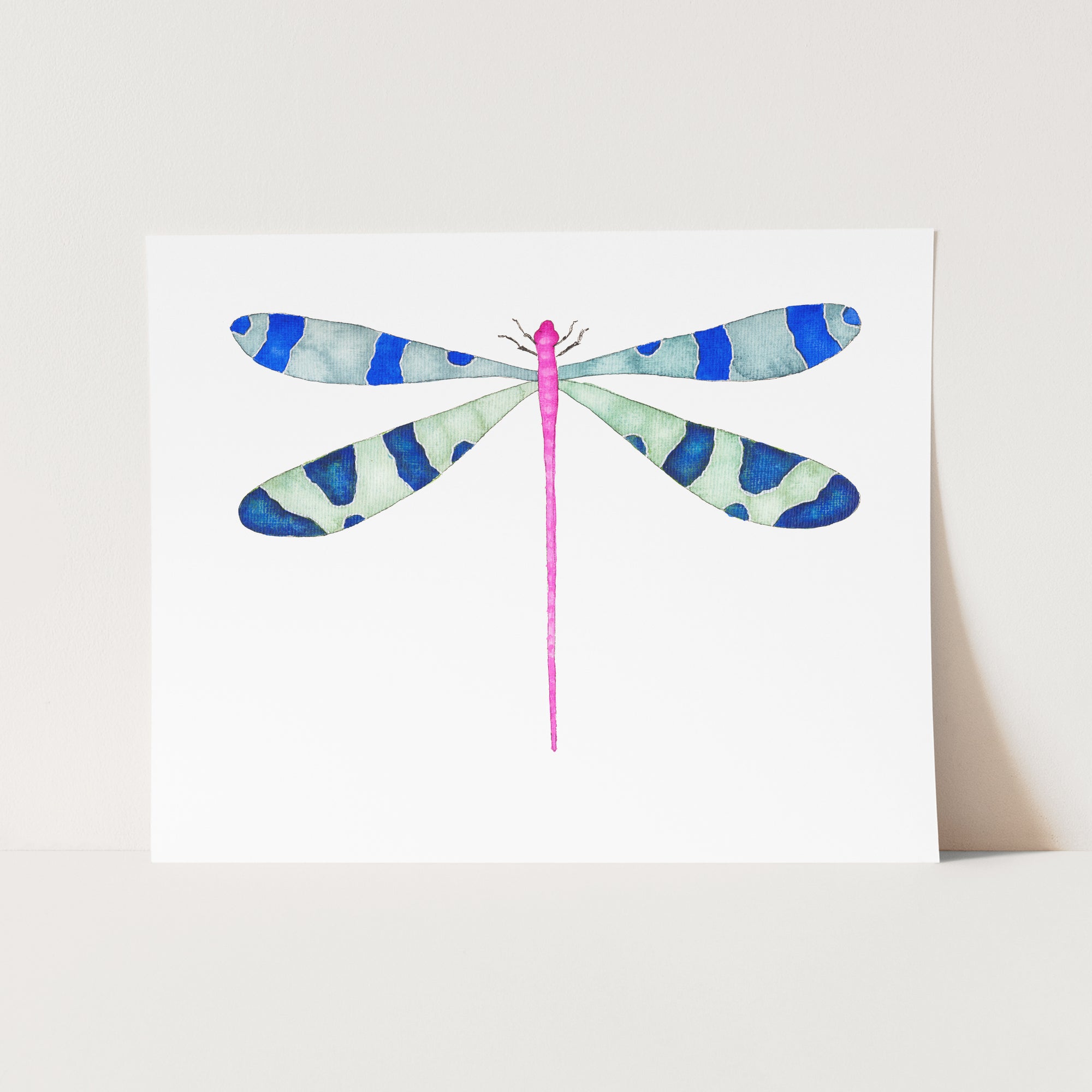 a card with a watercolor painting of a dragonfly