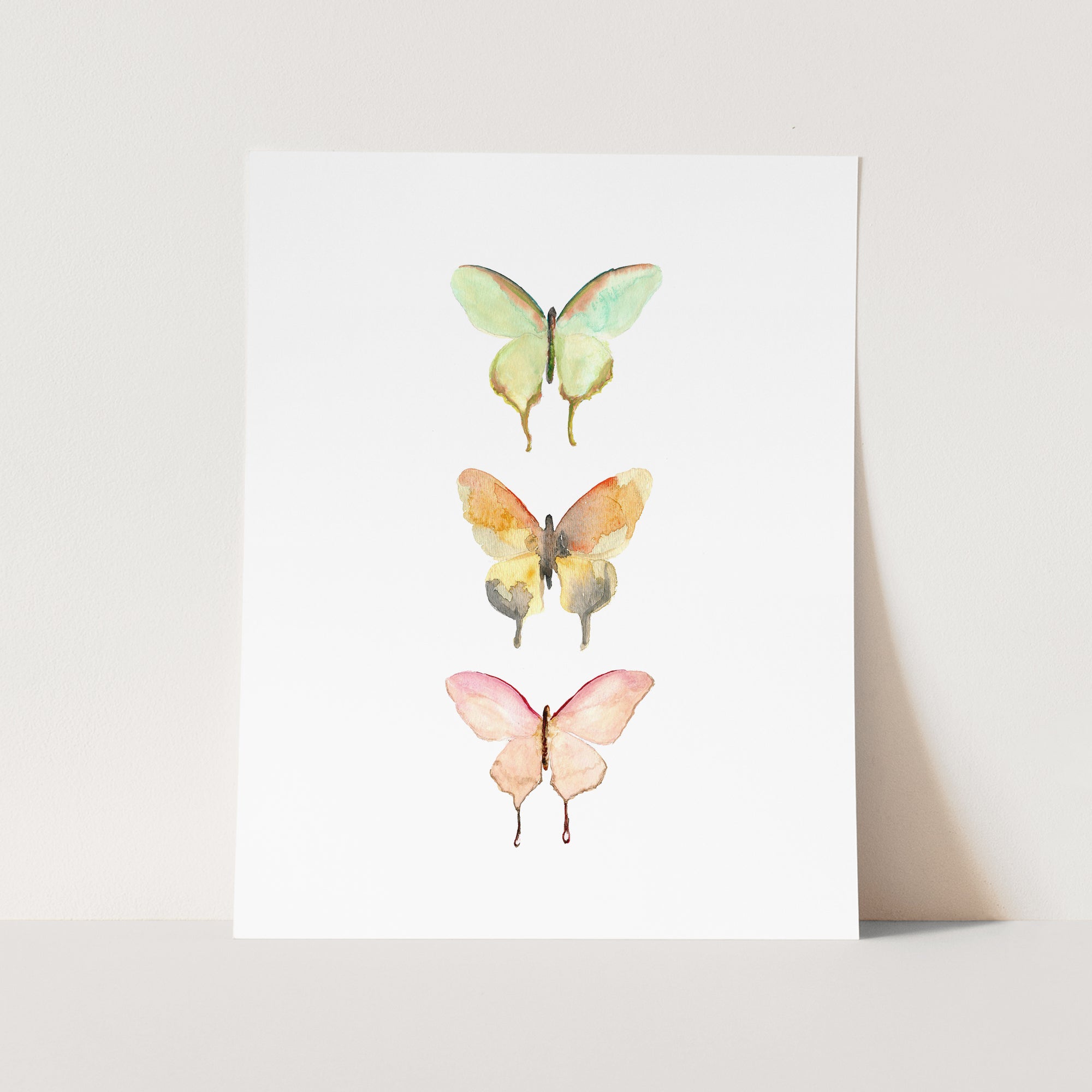 a card with three butterflies painted on it