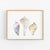 three seashells on a white background in a wooden frame