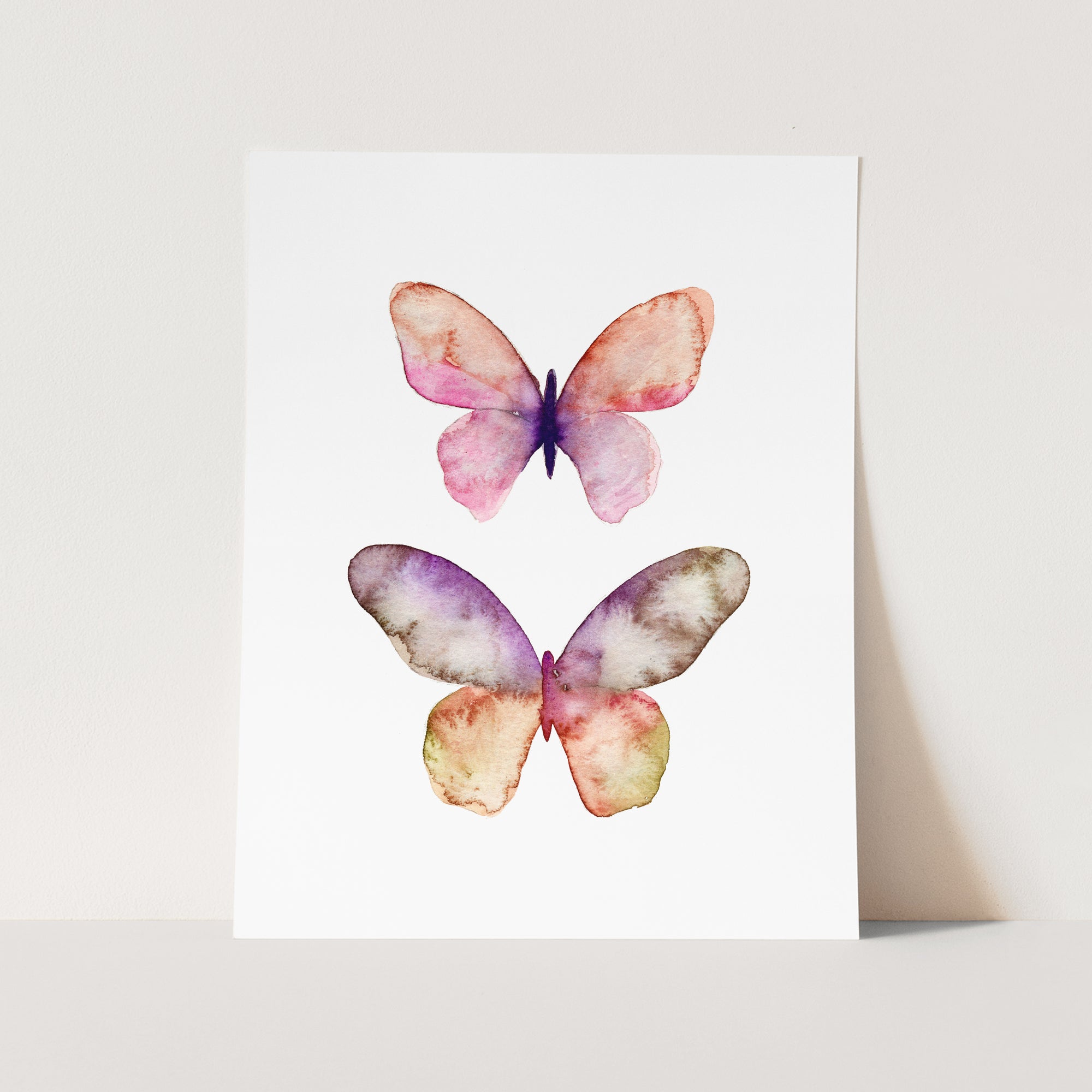 a watercolor painting of two butterflies on a white background