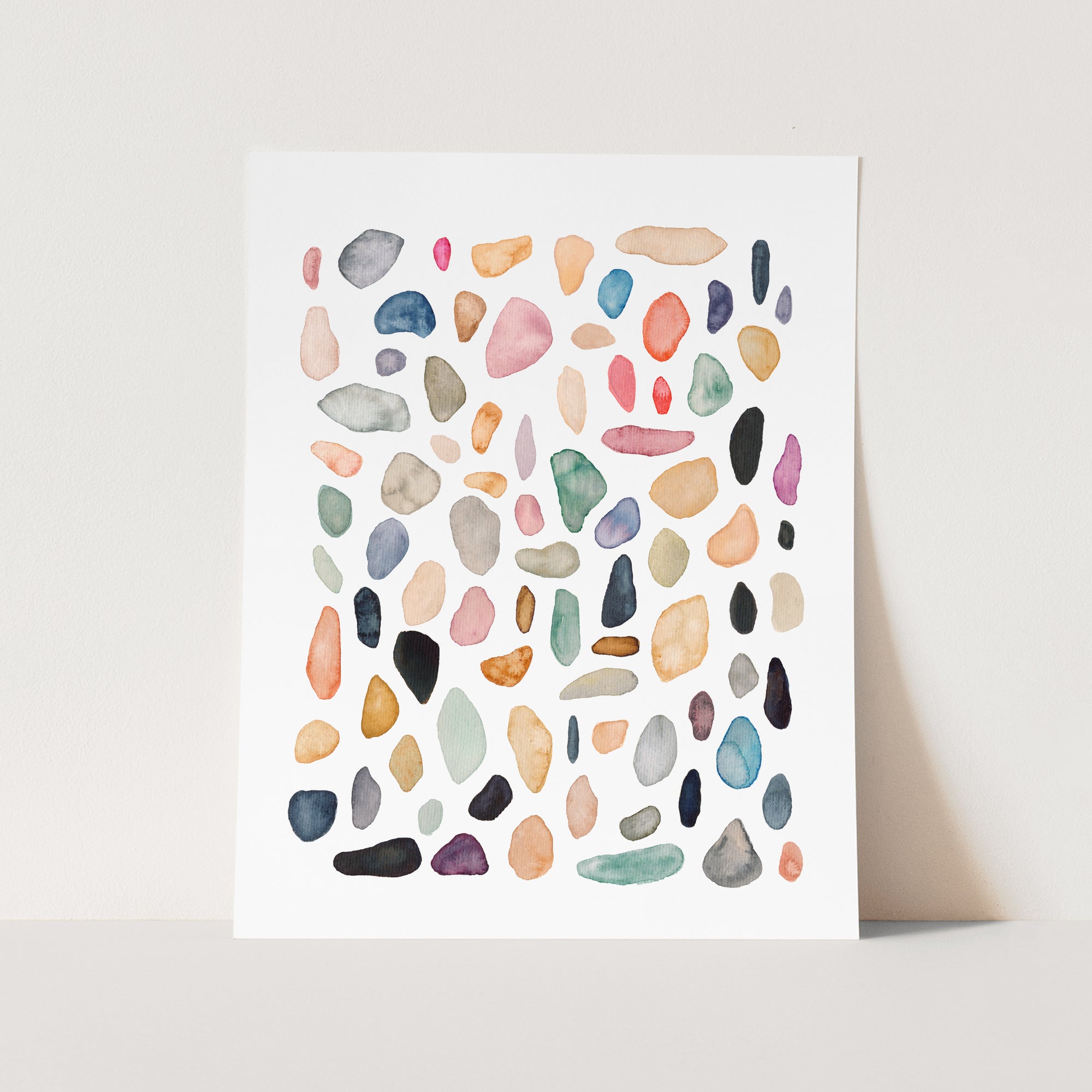 a watercolor painting of rocks on a white background