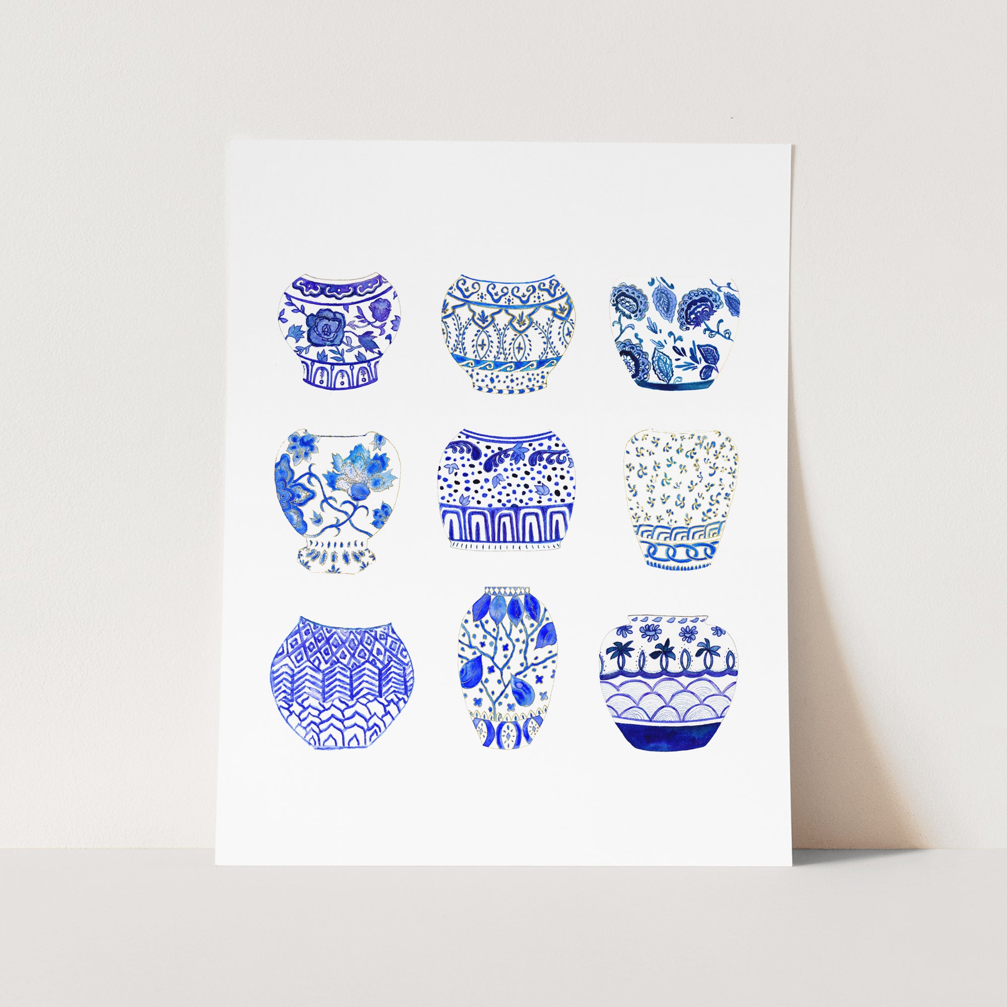 a white card with blue and white vases on it