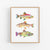 a painting of three fish on a white wall