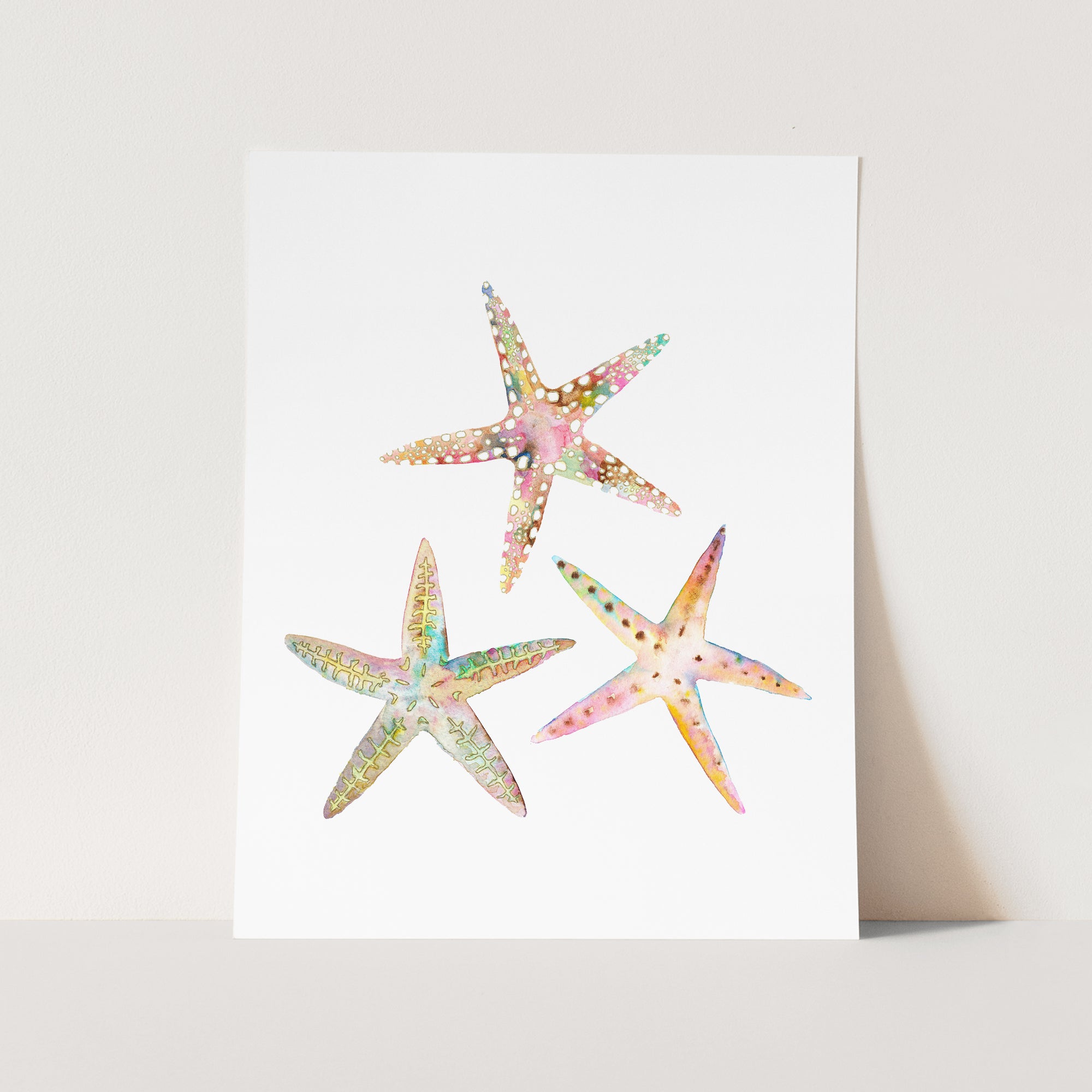 a card with three starfishs painted on it