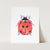 a card with a watercolor drawing of a ladybug
