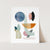 a card with a painting of abstract shapes