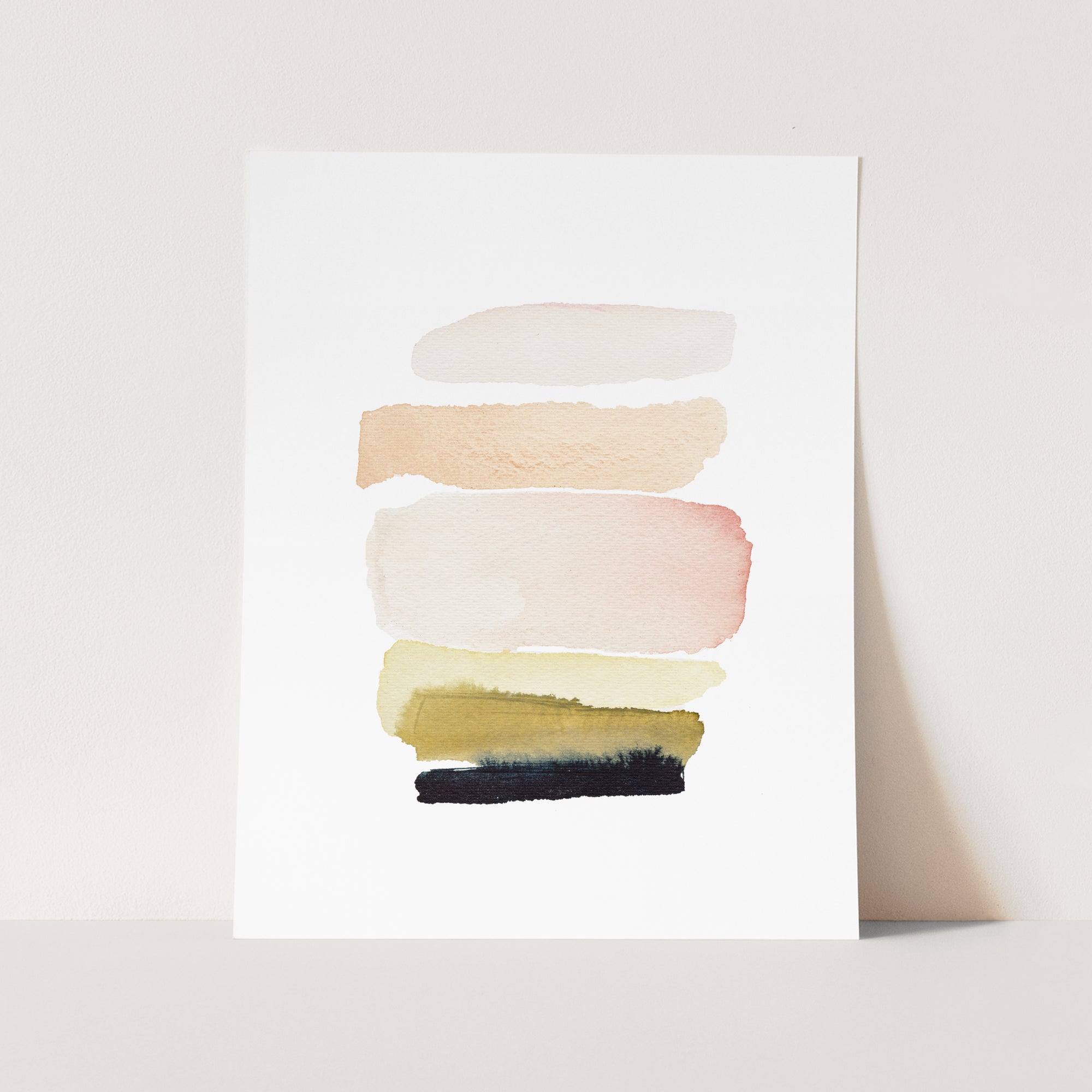 a white card with a painting of different colors